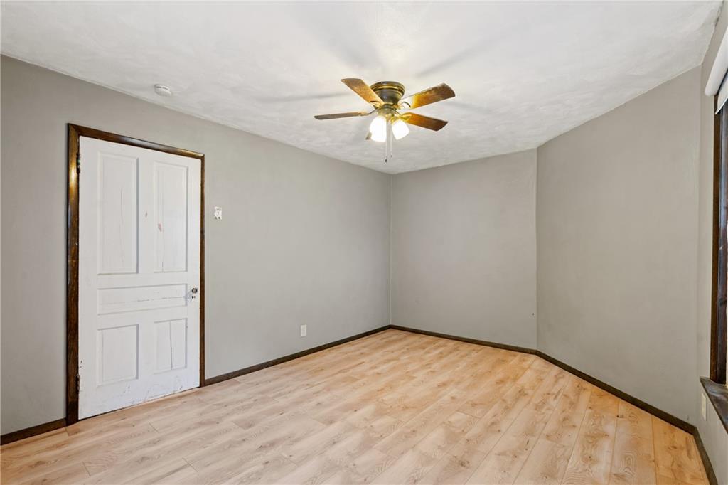 723 Freeport Road Creighton, PA 15030 - Photo 12 of 27 an empty room with a chandelier fan and wooden floor