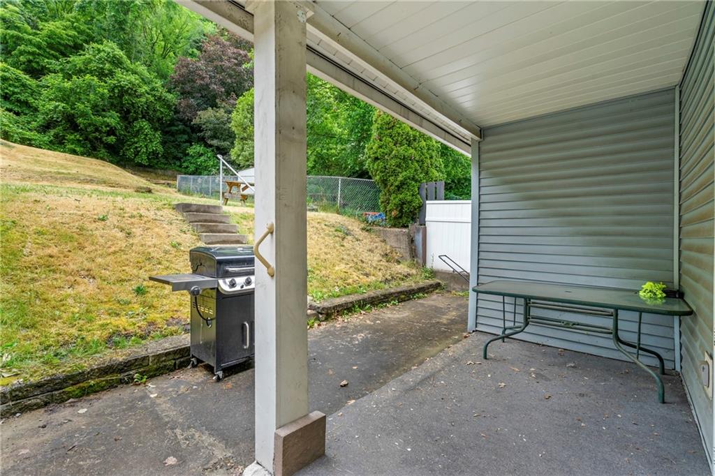 723 Freeport Road Creighton, PA 15030 - Photo 21 of 27 a view of a porch with wooden floor and a bench in the patio