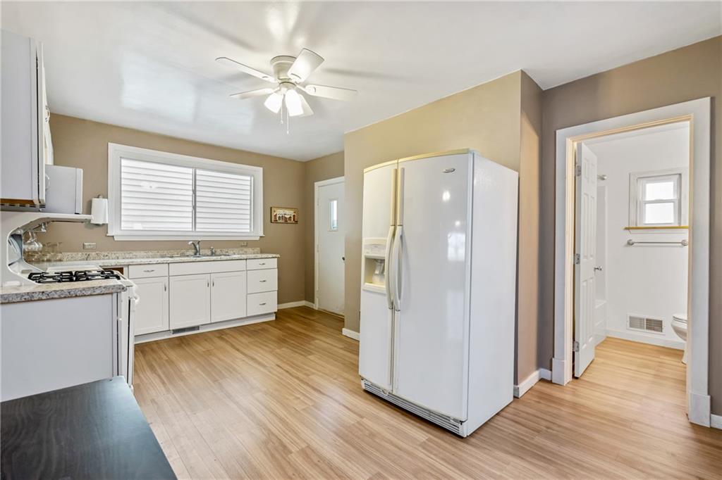723 Freeport Road Creighton, PA 15030 - Photo 3 of 27 a kitchen with a refrigerator and a stove top oven