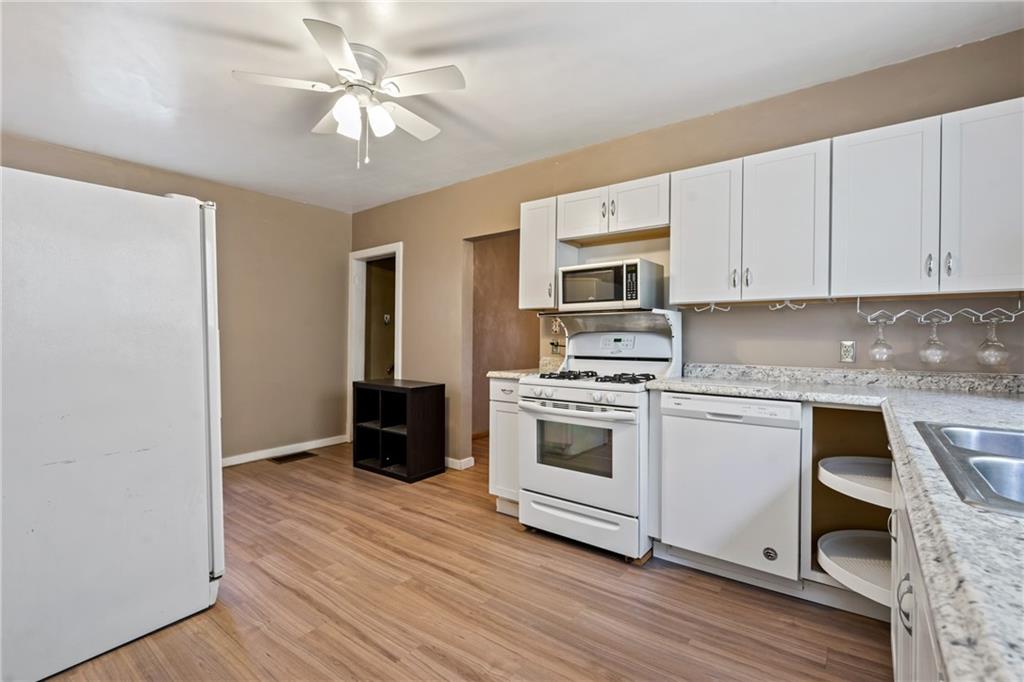 723 Freeport Road Creighton, PA 15030 - Photo 4 of 27 a kitchen with granite countertop a stove a sink and a refrigerator