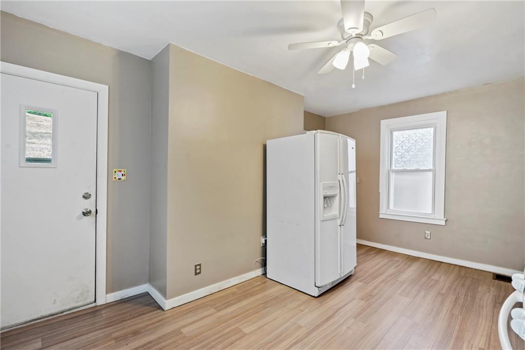 723 Freeport Road Creighton, PA 15030 - Photo 5 of 27 a view of a livingroom with wooden floor and a ceiling fan