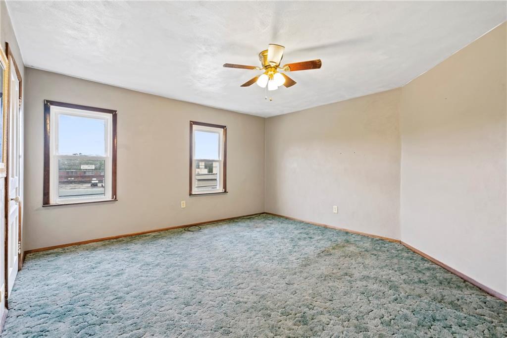 723 Freeport Road Creighton, PA 15030 - Photo 6 of 27 an empty room with windows and fan