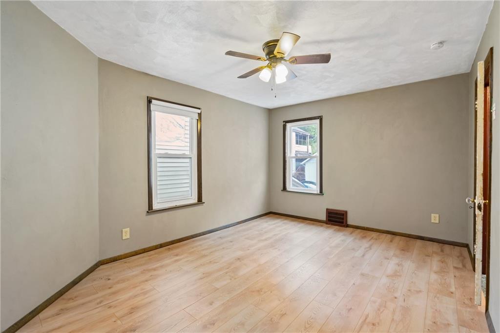 723 Freeport Road Creighton, PA 15030 - Photo 9 of 27 an empty room with windows and fan