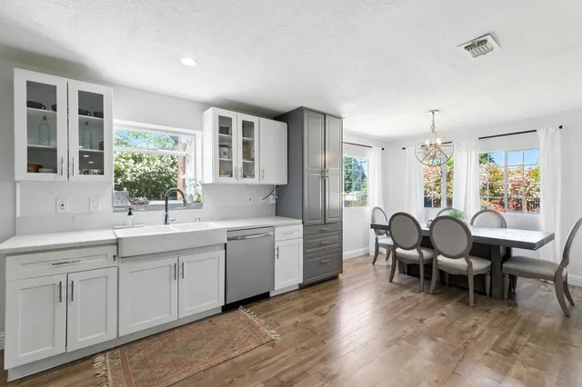 a view of a dining room and livingroom with furniture window and wooden floor