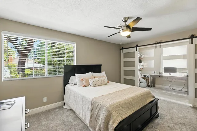 a bedroom with a large bed and a large window