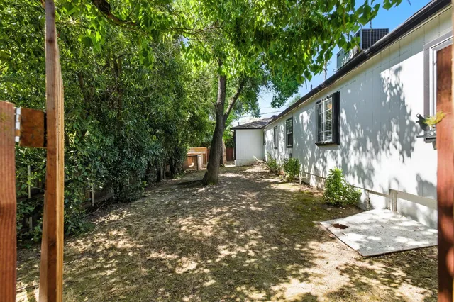 a view of a house with backyard and sitting area