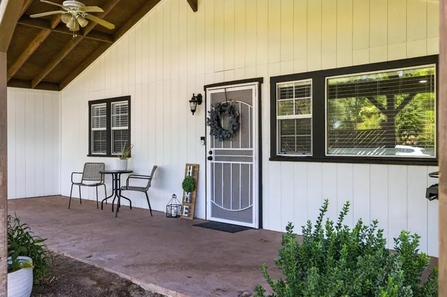 a front view of a house with outdoor seating