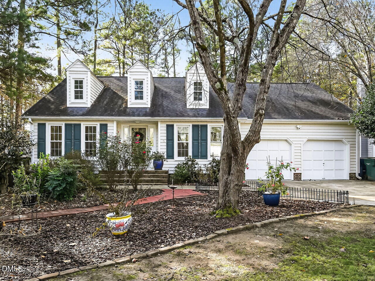 a view of a house with backyard sitting area and garden