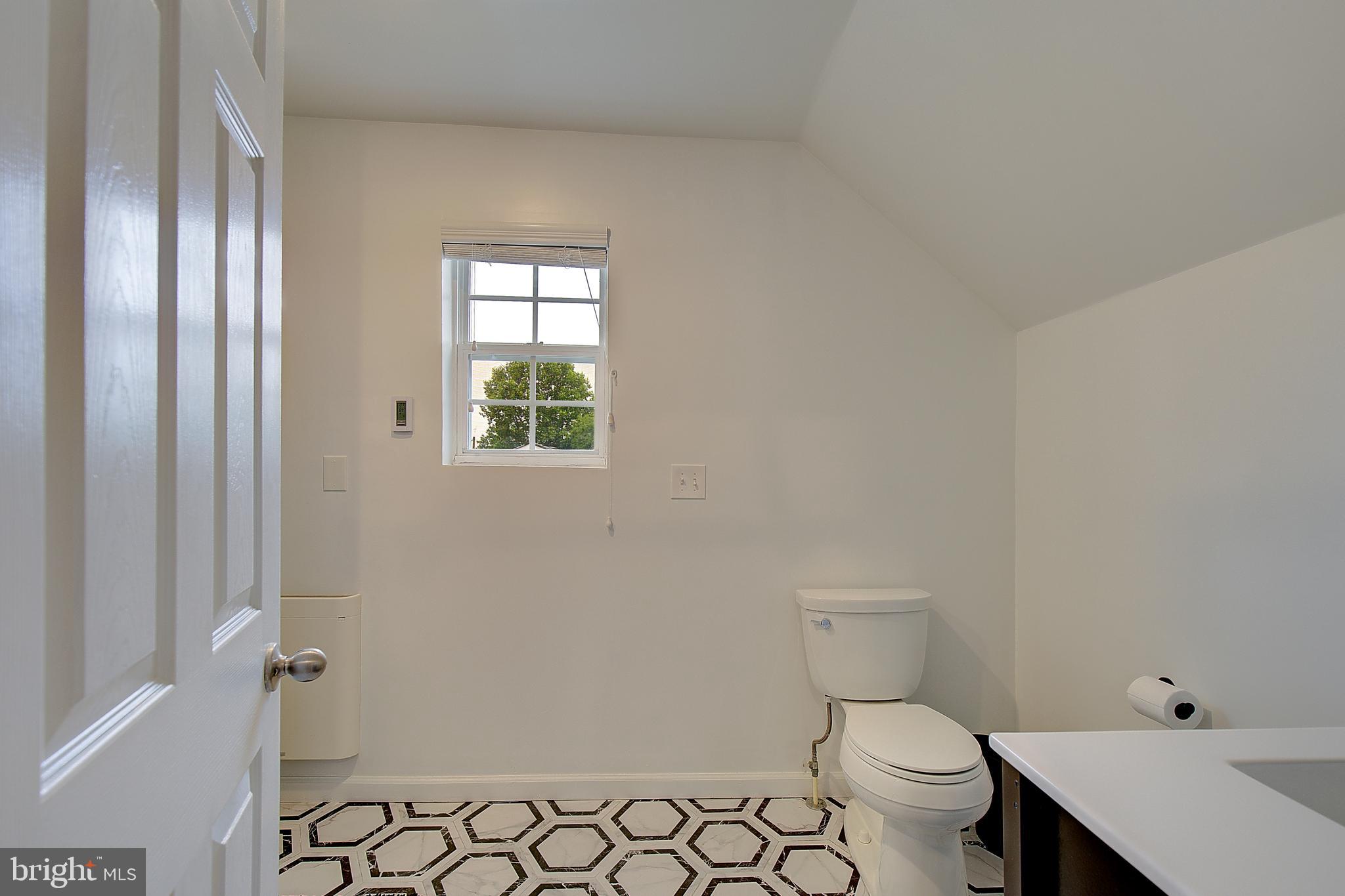 403 Venton Road Edgewater, MD 21037 - Photo 43 of 62 a bathroom with a toilet a sink and a window