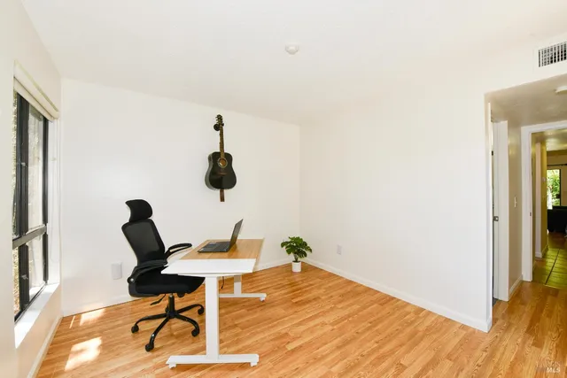 a workspace with furniture and wooden floor