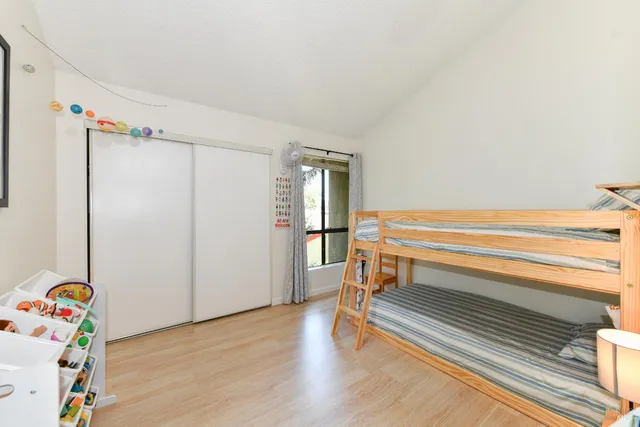a view of room with wooden floor and closet