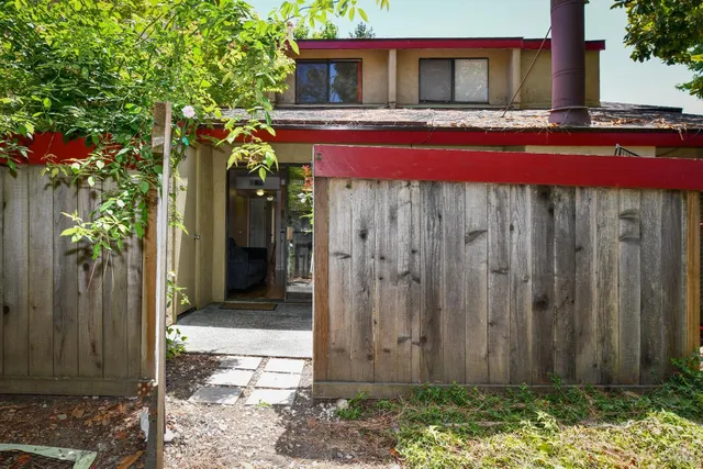 a view of a house with backyard sitting area and garden