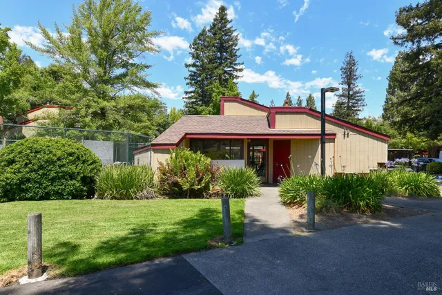 a sign that is in front of a brick house