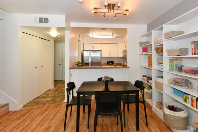 a view of a dining room with furniture and wooden floor