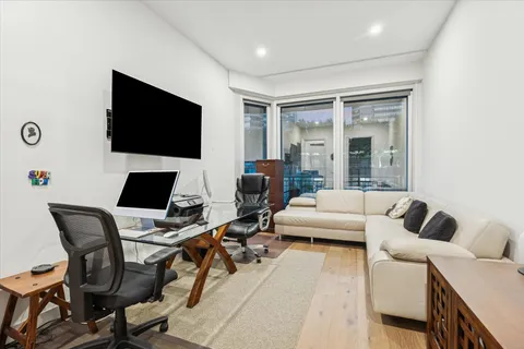 a bathroom with a toilet a sink a glass door a shower and a mirror