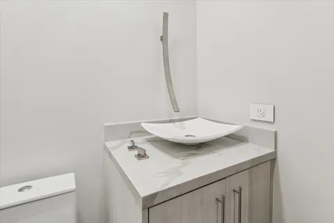 a bathroom with a shower sink and mirror