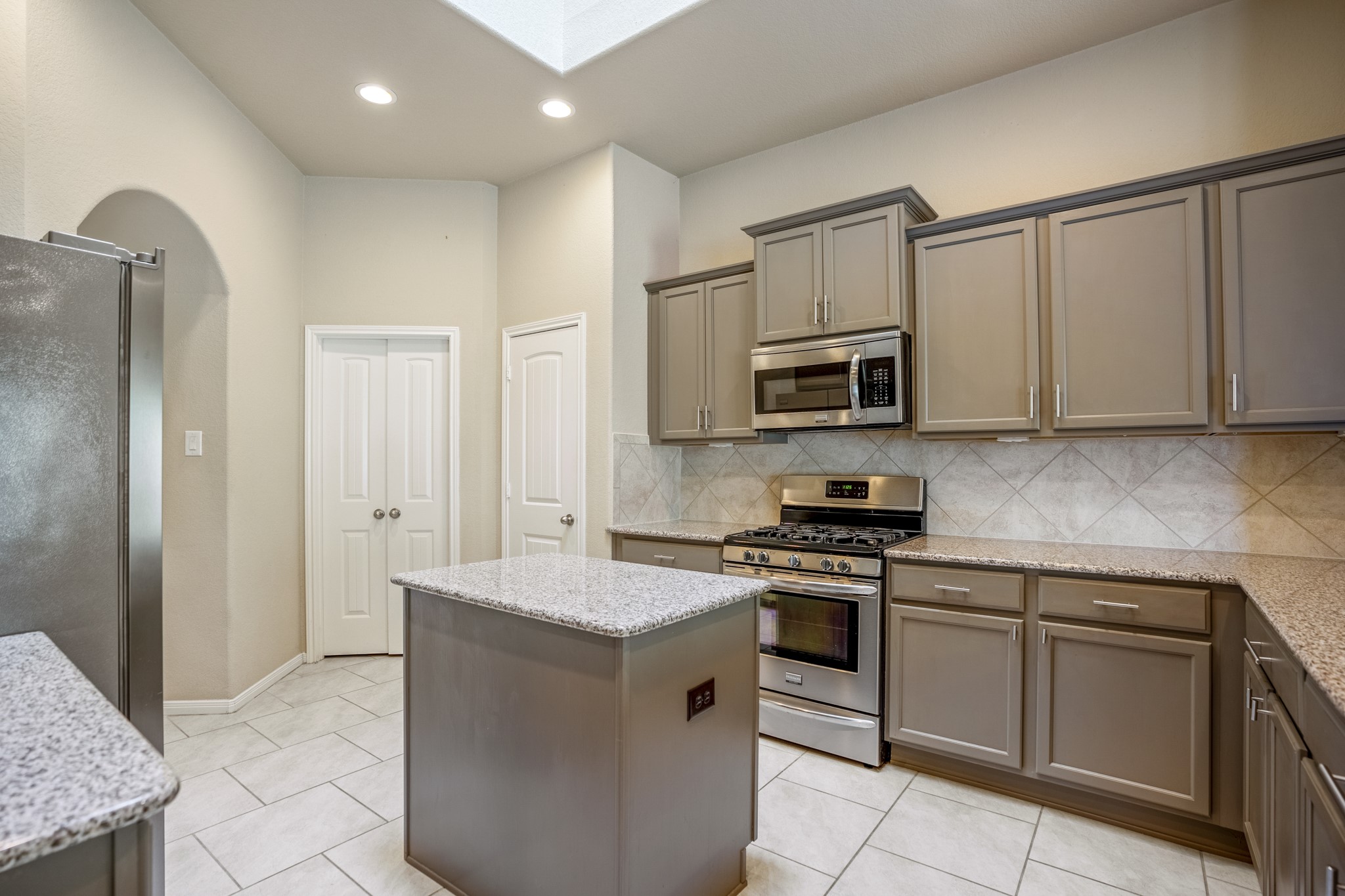 5319 Claymore Meadow Lane Spring, TX 77389 - Photo 14 of 34 a kitchen with granite countertop white cabinets stainless steel appliances and a counter space