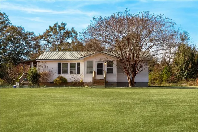 a front view of a house with a garden