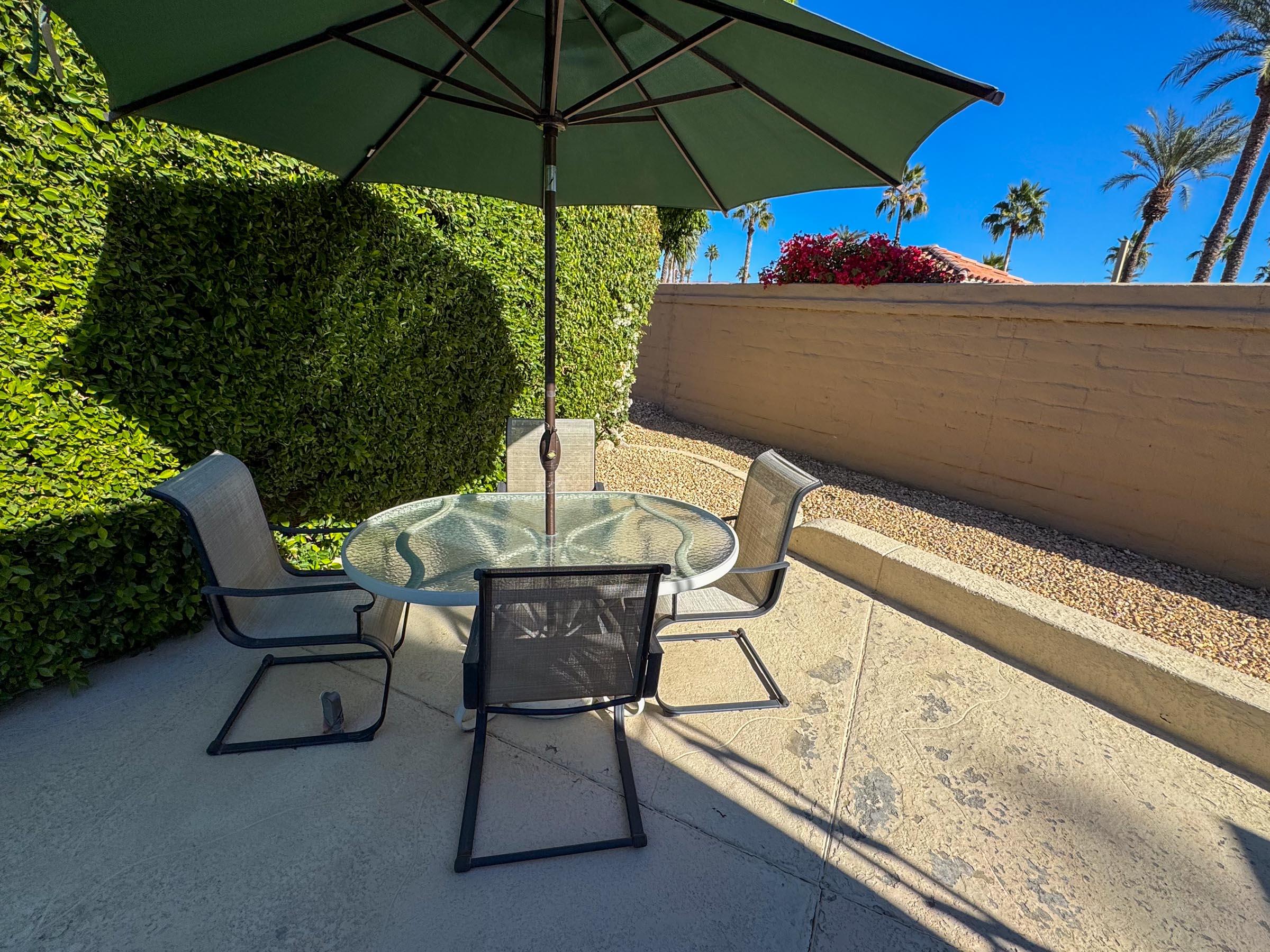 a view of an outdoor sitting area with furniture