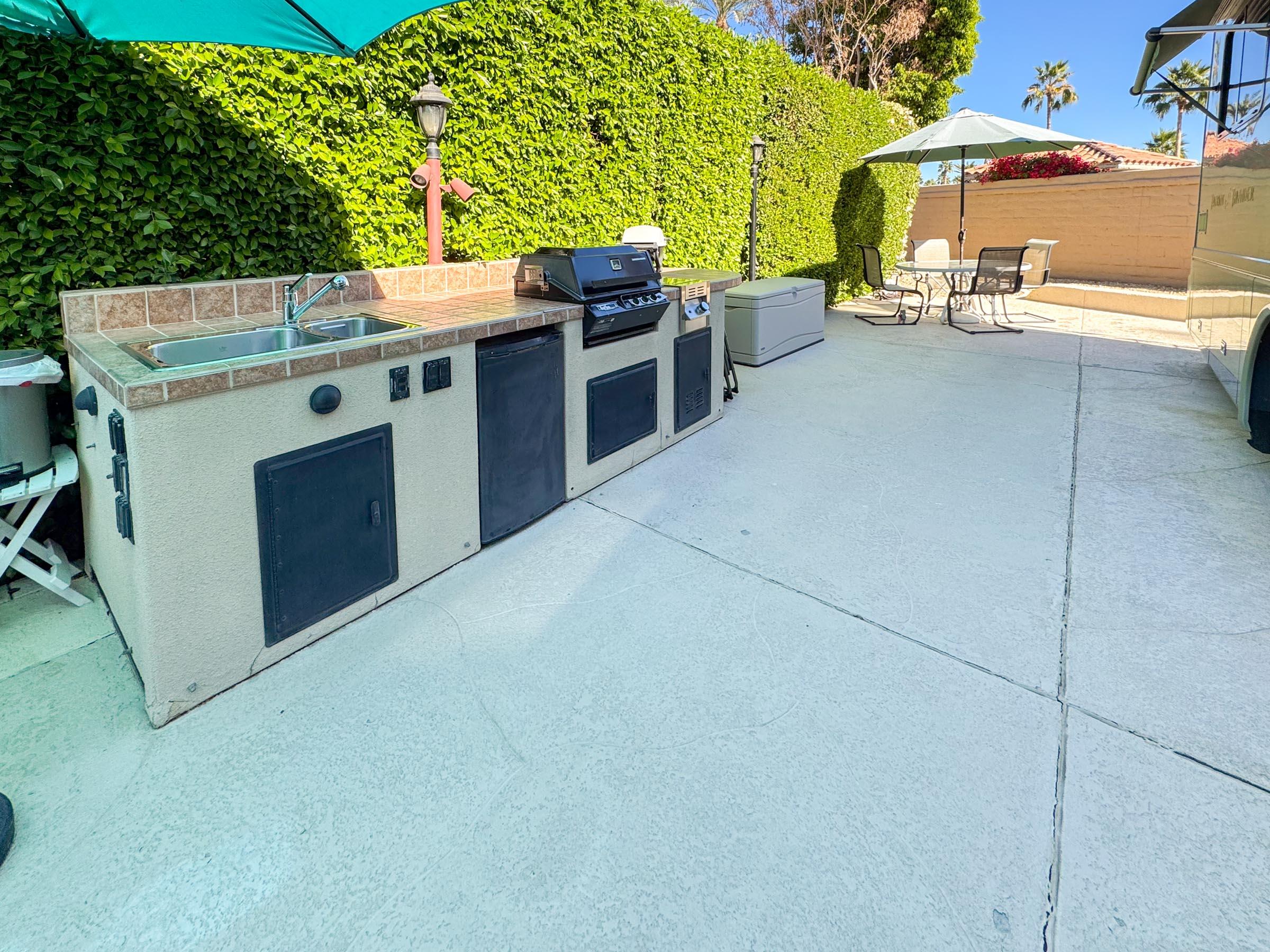 80394 Ave 48, Unit 105 Indio, CA 92201 - Photo 3 of 13 a view of a kitchen with a stove and a table