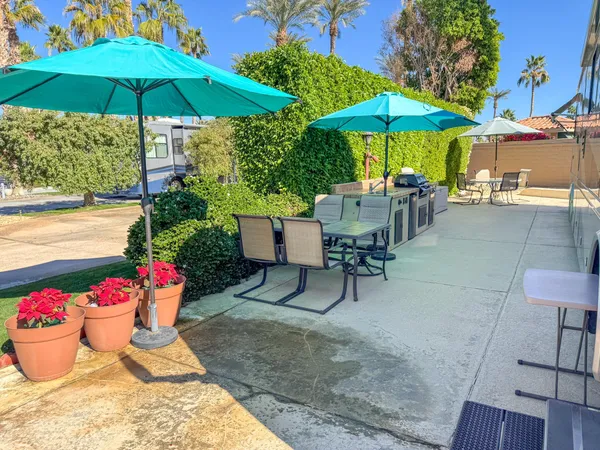 a view of a backyard with sitting area and furniture