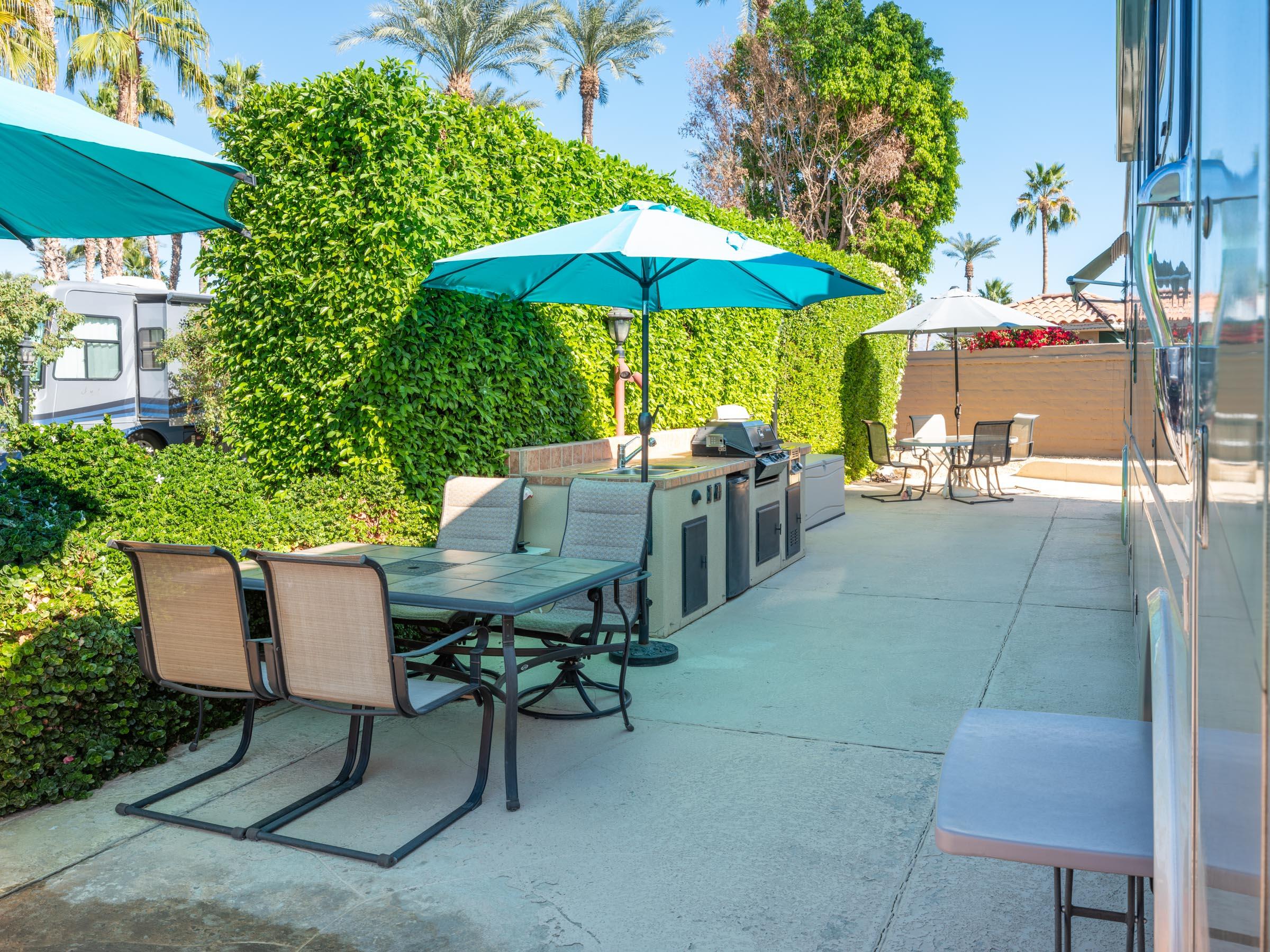 80394 Ave 48, Unit 105 Indio, CA 92201 - Photo 10 of 13 a patio with a table and chairs under an umbrella