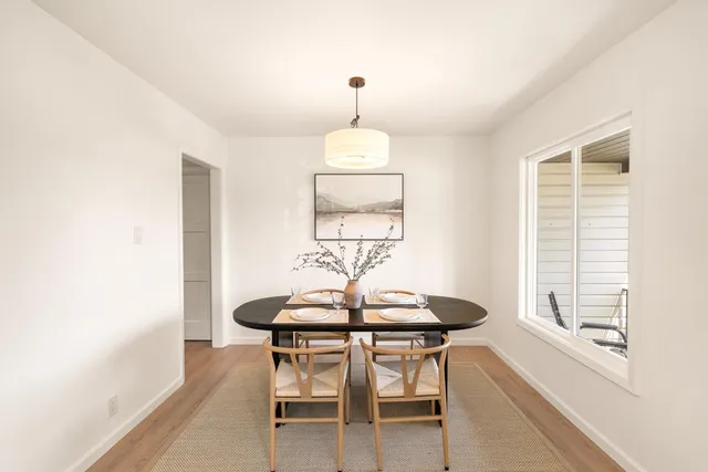 a dining room with furniture and window