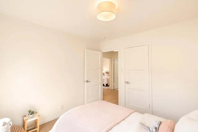 a bedroom with a bed and a closet