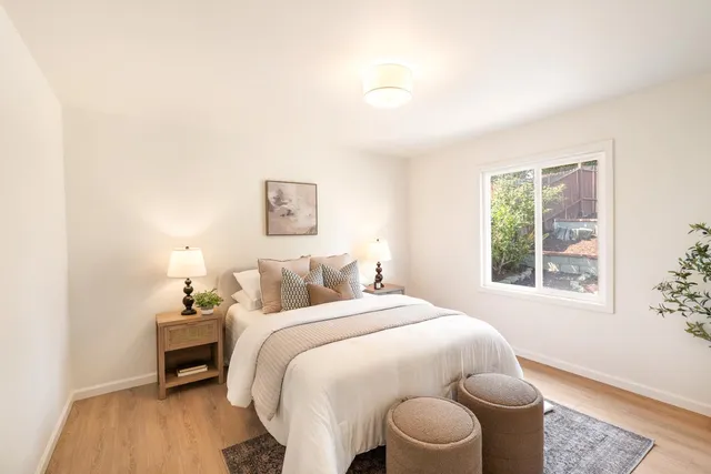 a bedroom with a bed and a window