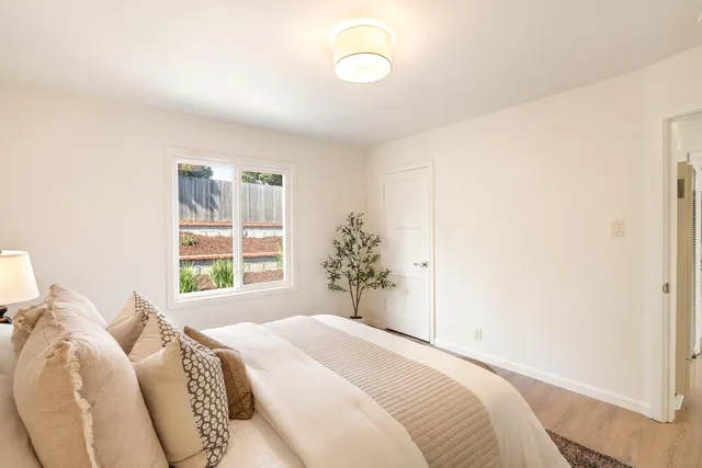 a bedroom with a bed and a window