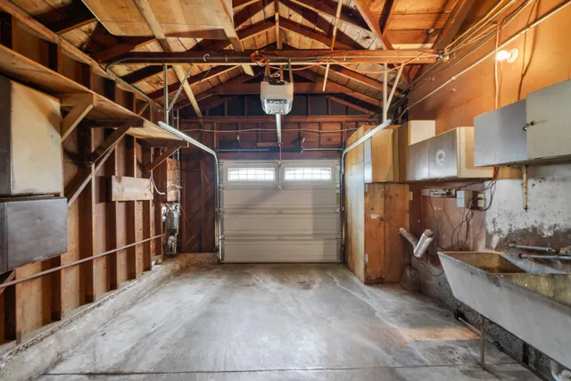 a view of a garage with wooden floors and stairs