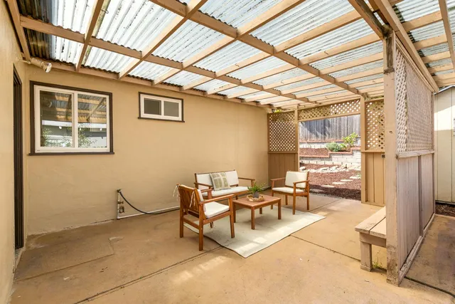 a balcony with furniture and a potted plant