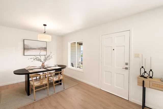 a dining room with furniture and window