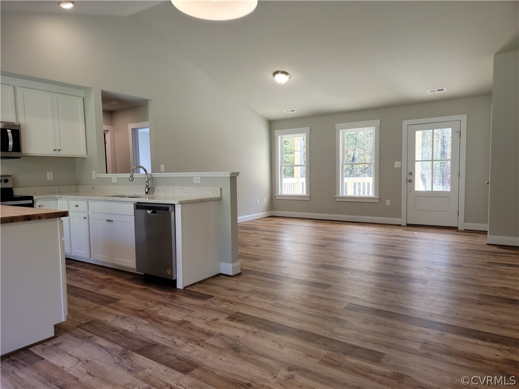 16510 Exter Mill Road Chesterfield, VA 23838 - Photo 10 of 44 a view of a kitchen and an empty room with wooden floor and a kitchen