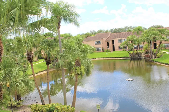 a view of a patio with table and chairs and potted plants