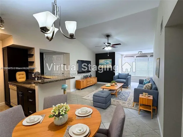 a dining room with furniture a chandelier and wooden floor