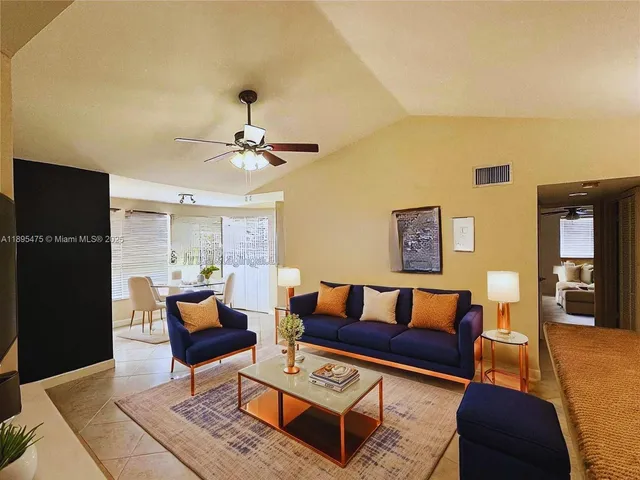 a living room with furniture a rug and a chandelier