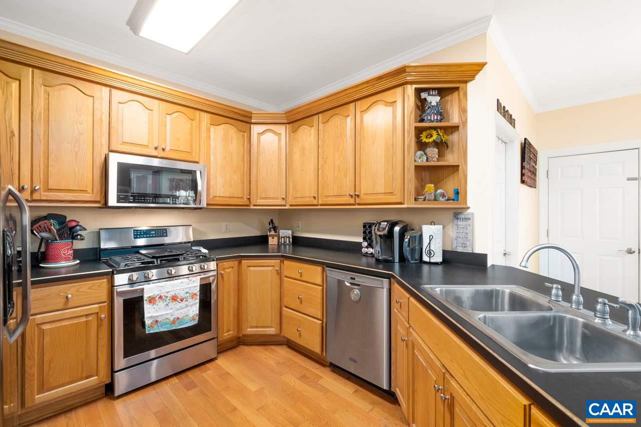 323 Buffalo Run Road Stanardsville, VA 22973 - Photo 15 of 37 a kitchen with stainless steel appliances granite countertop a sink a stove a microwave and cabinets