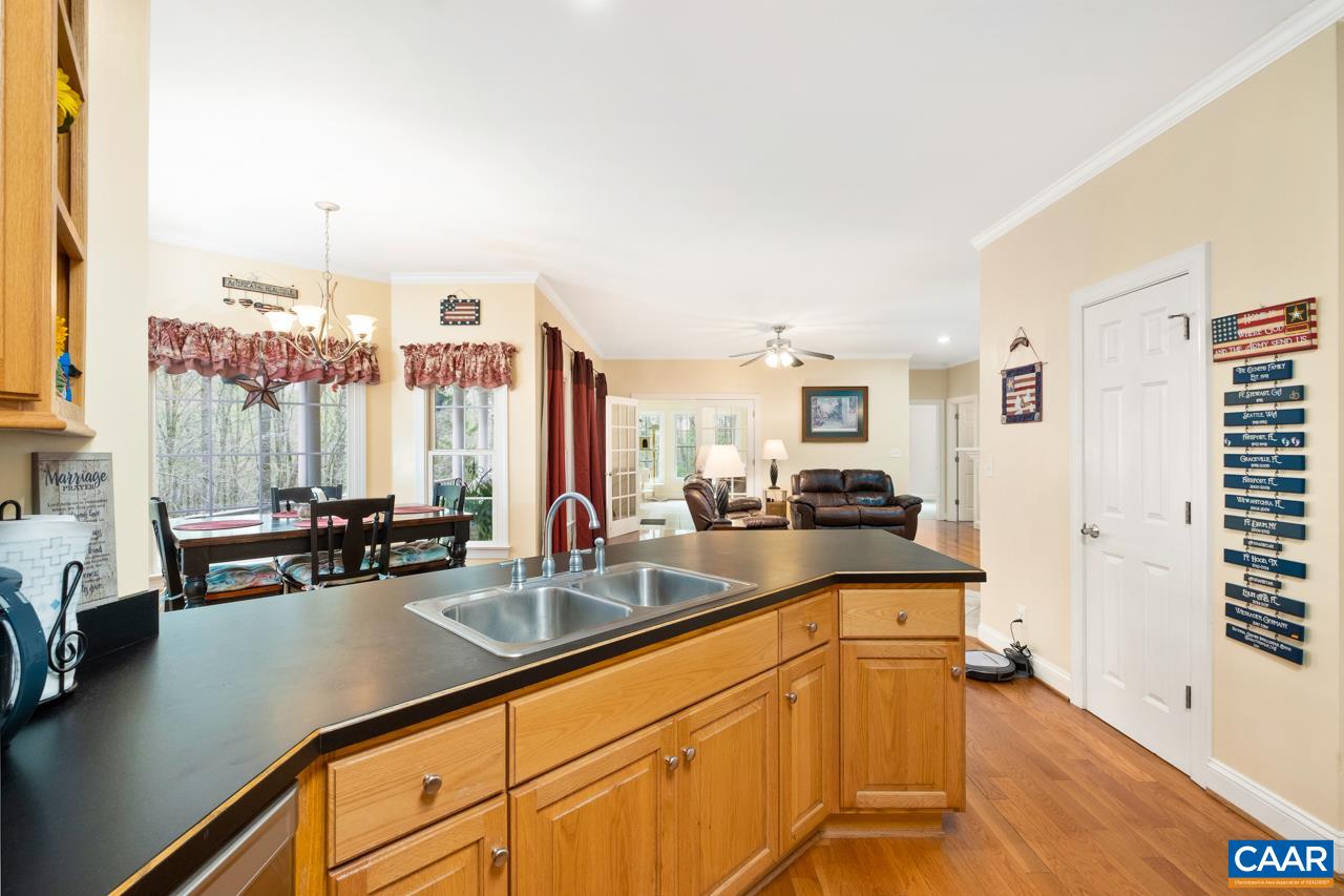 323 Buffalo Run Road Stanardsville, VA 22973 - Photo 16 of 37 a very nice looking living room with a large window and kitchen view