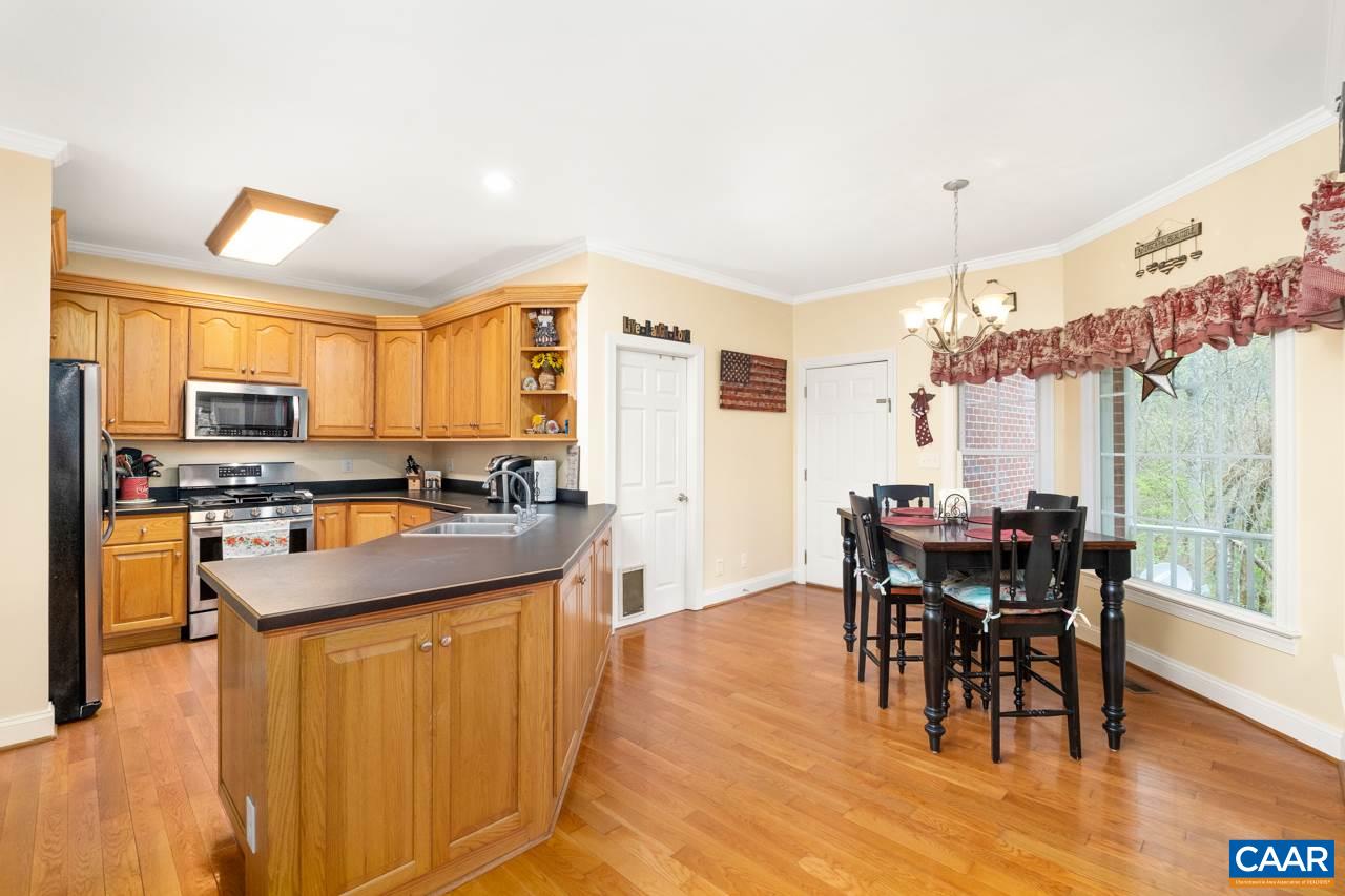 323 Buffalo Run Road Stanardsville, VA 22973 - Photo 17 of 37 a kitchen with stainless steel appliances a table and chairs in it