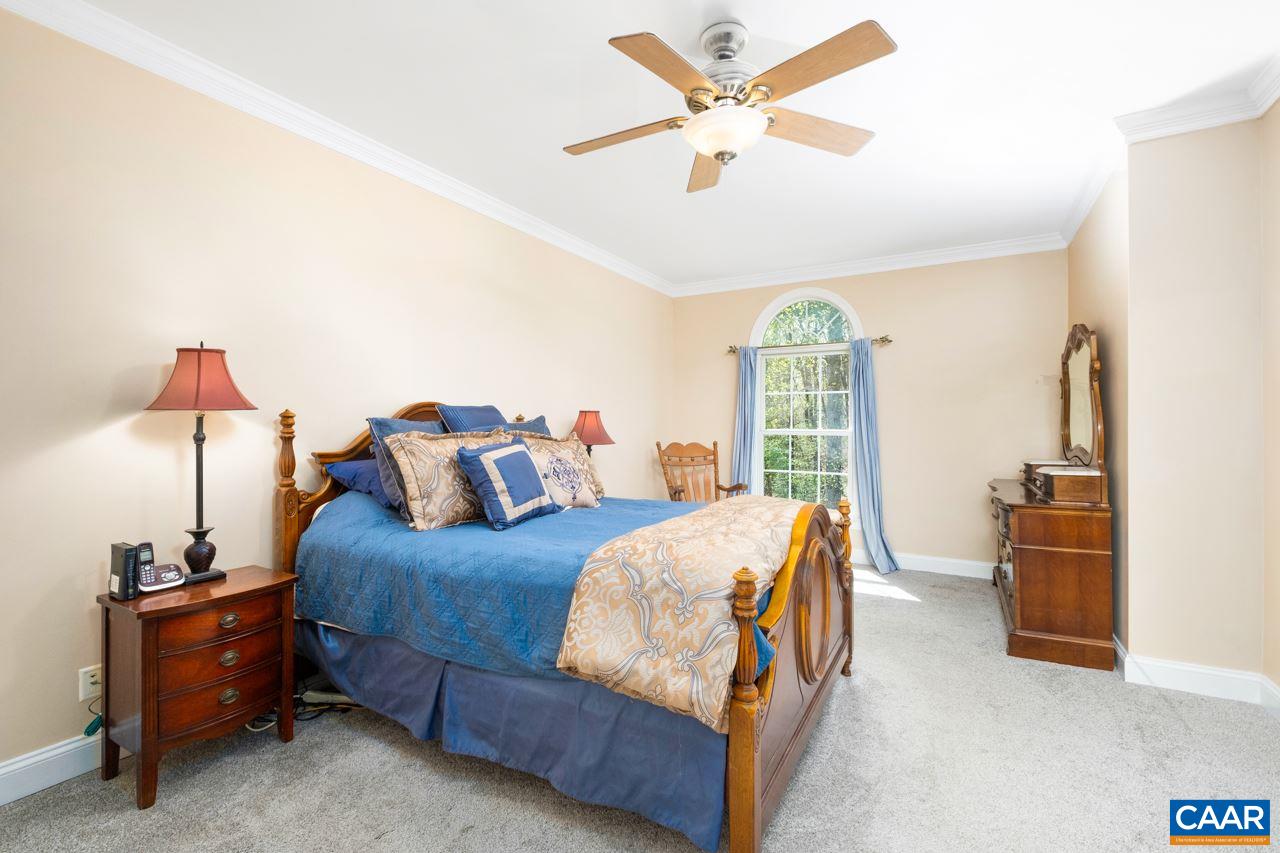 323 Buffalo Run Road Stanardsville, VA 22973 - Photo 21 of 37 a bedroom with a bed and a chandelier
