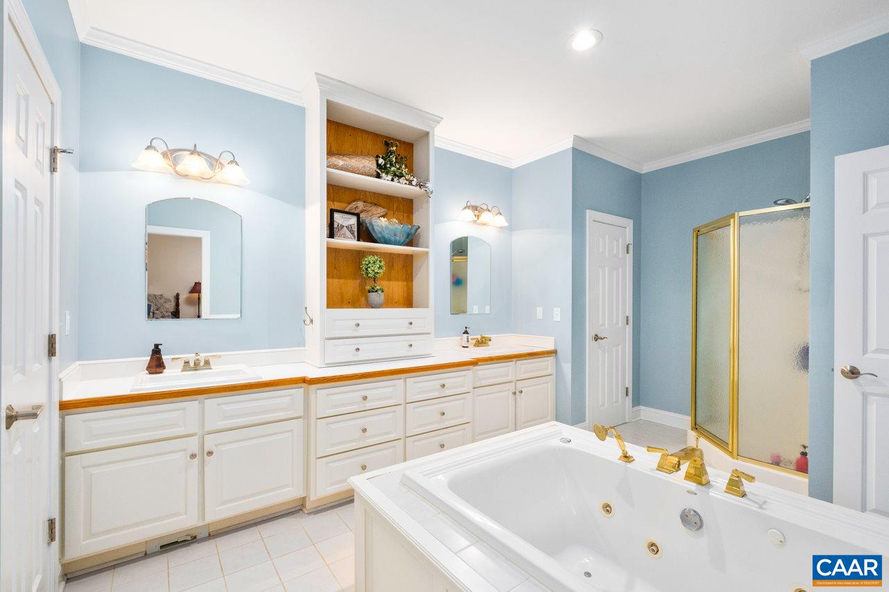 323 Buffalo Run Road Stanardsville, VA 22973 - Photo 23 of 37 a spacious bathroom with a tub sink and mirror