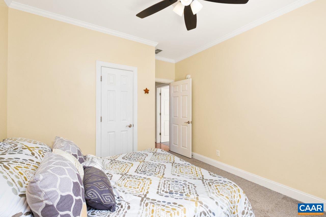 323 Buffalo Run Road Stanardsville, VA 22973 - Photo 27 of 37 a bedroom with a bed and a chandelier
