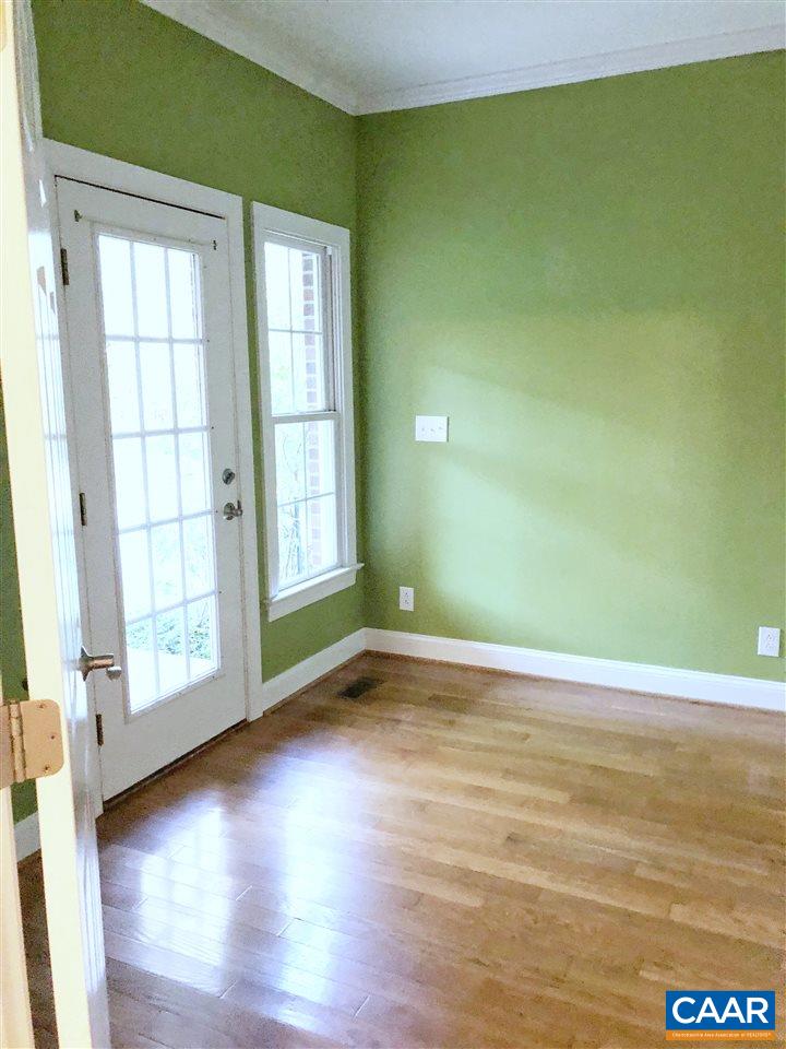 323 Buffalo Run Road Stanardsville, VA 22973 - Photo 30 of 37 an empty room with wooden floor and windows with curtains