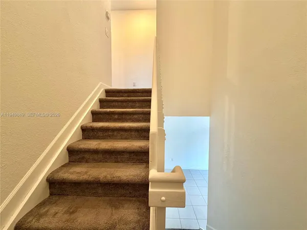 a view of staircase with white walls