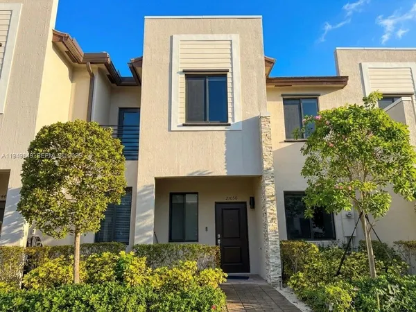a view of a patio with couches table and chairs and potted plants