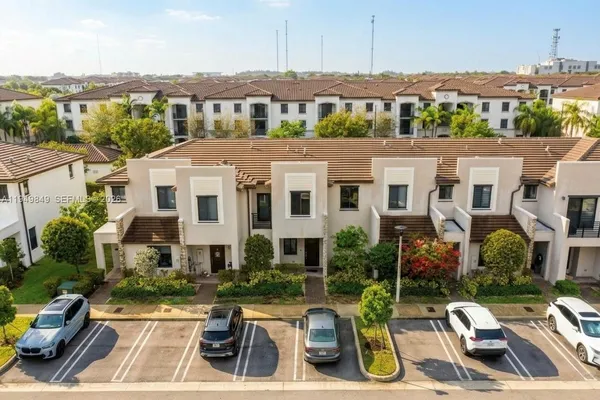 an aerial view of multiple houses with a yard
