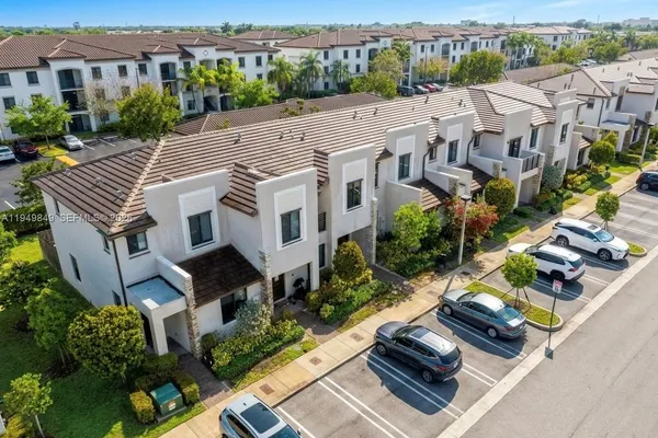 a view of house with yard and outdoor seating