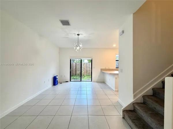 a view of a kitchen with a sink and a chandelier