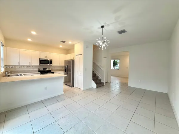 a view of a kitchen with a sink and cabinets